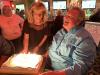 Larry is surprised and dazzled by all the candles on his birthday cake presented by Lisa at Smitty McGee's.